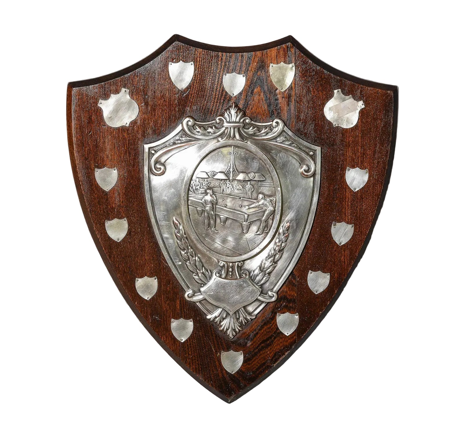 Wooden shield with silver emblem on a gray surface