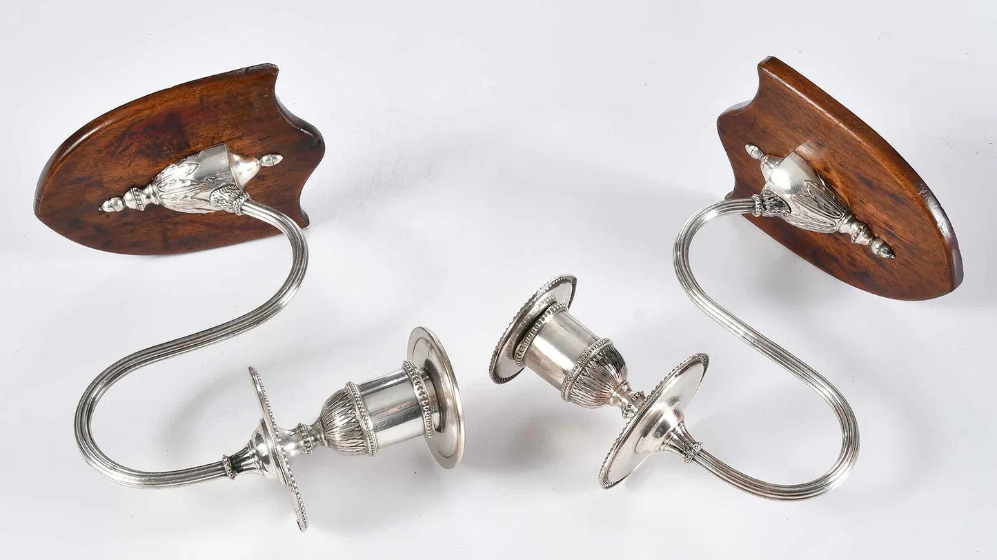 Pair of vintage wall sconces with wooden and metal design on a white background