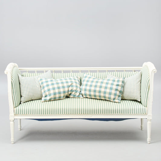 Gustavian-style painted banquette sofa with green striped upholstery front view