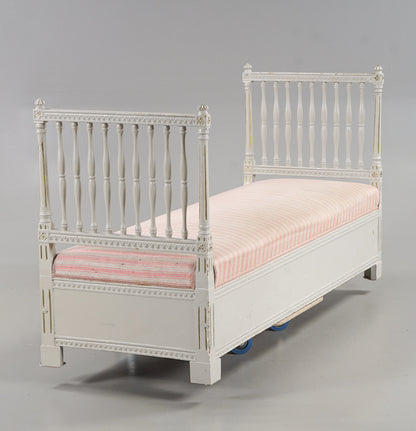 Angled view of Gustavian-style daybed bench with pink striped upholstery