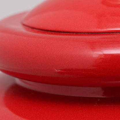 Close-up of red glazed ceramic surface on Kostka lamp