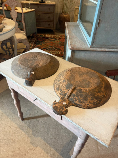 Two carved wooden bowls shown on a painted Swedish table in the showroom