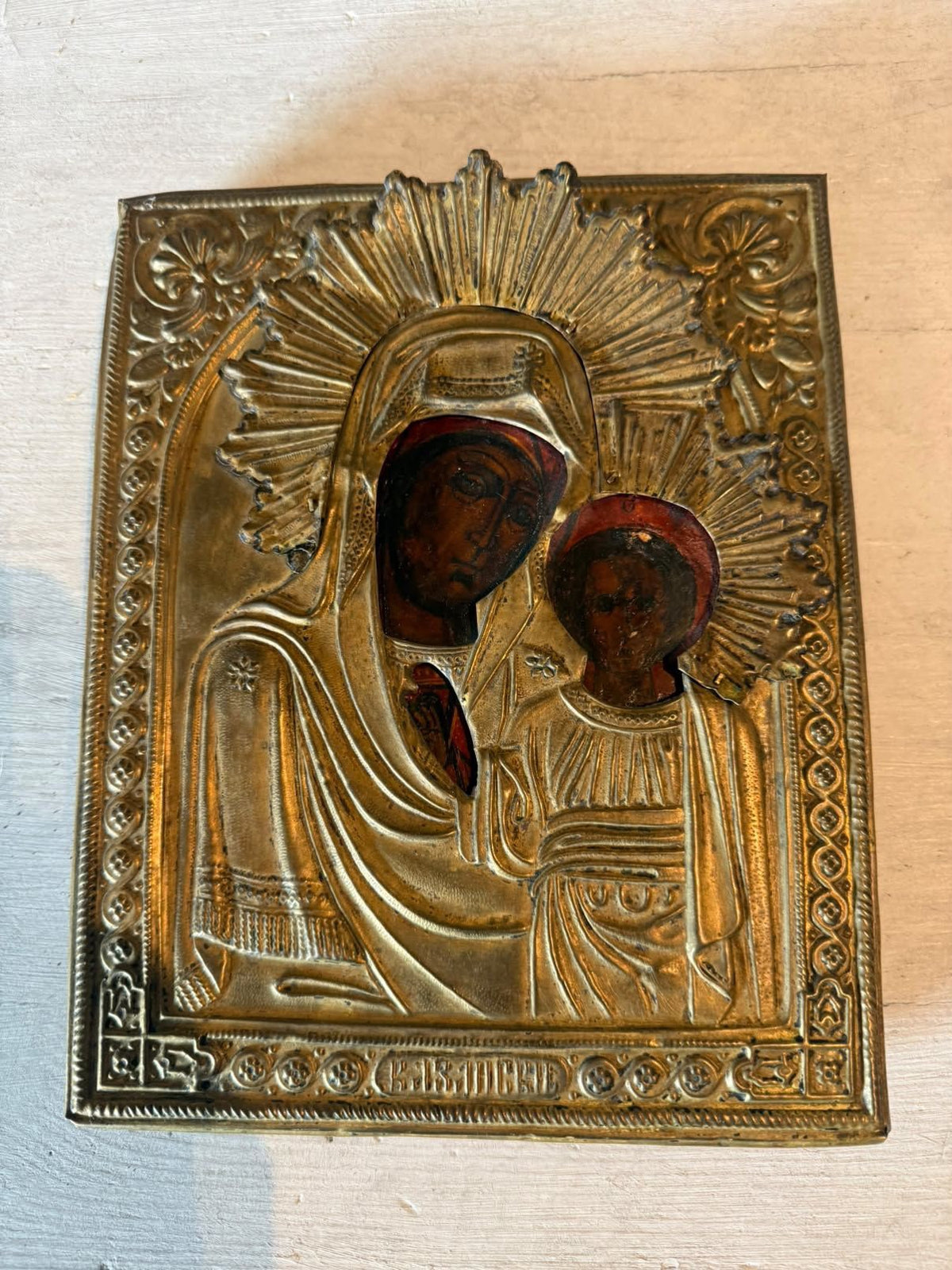Kazan Mother of God icon with brass cover, shown in natural light