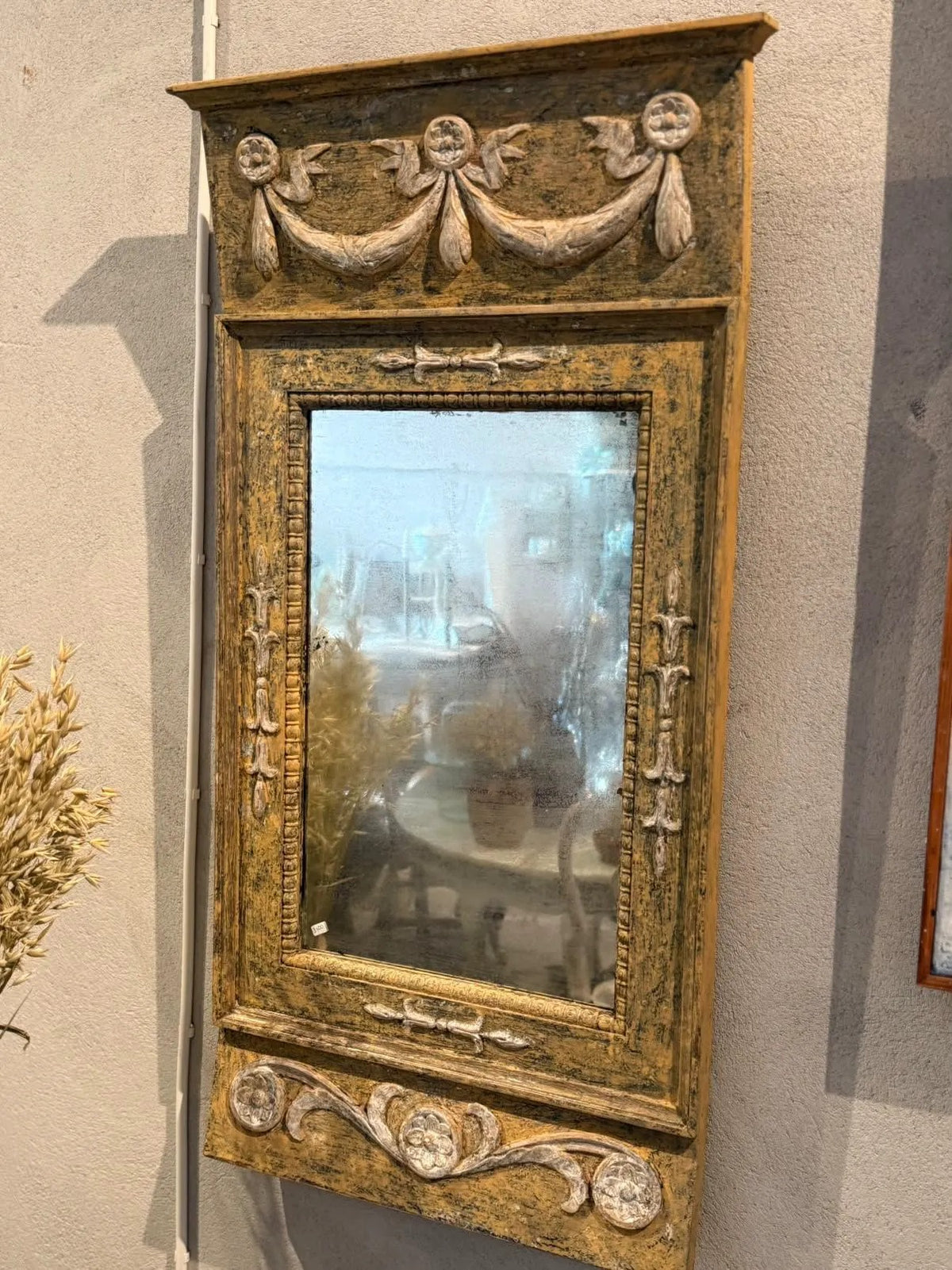 Swedish painted carved mirror hanging in the showroom