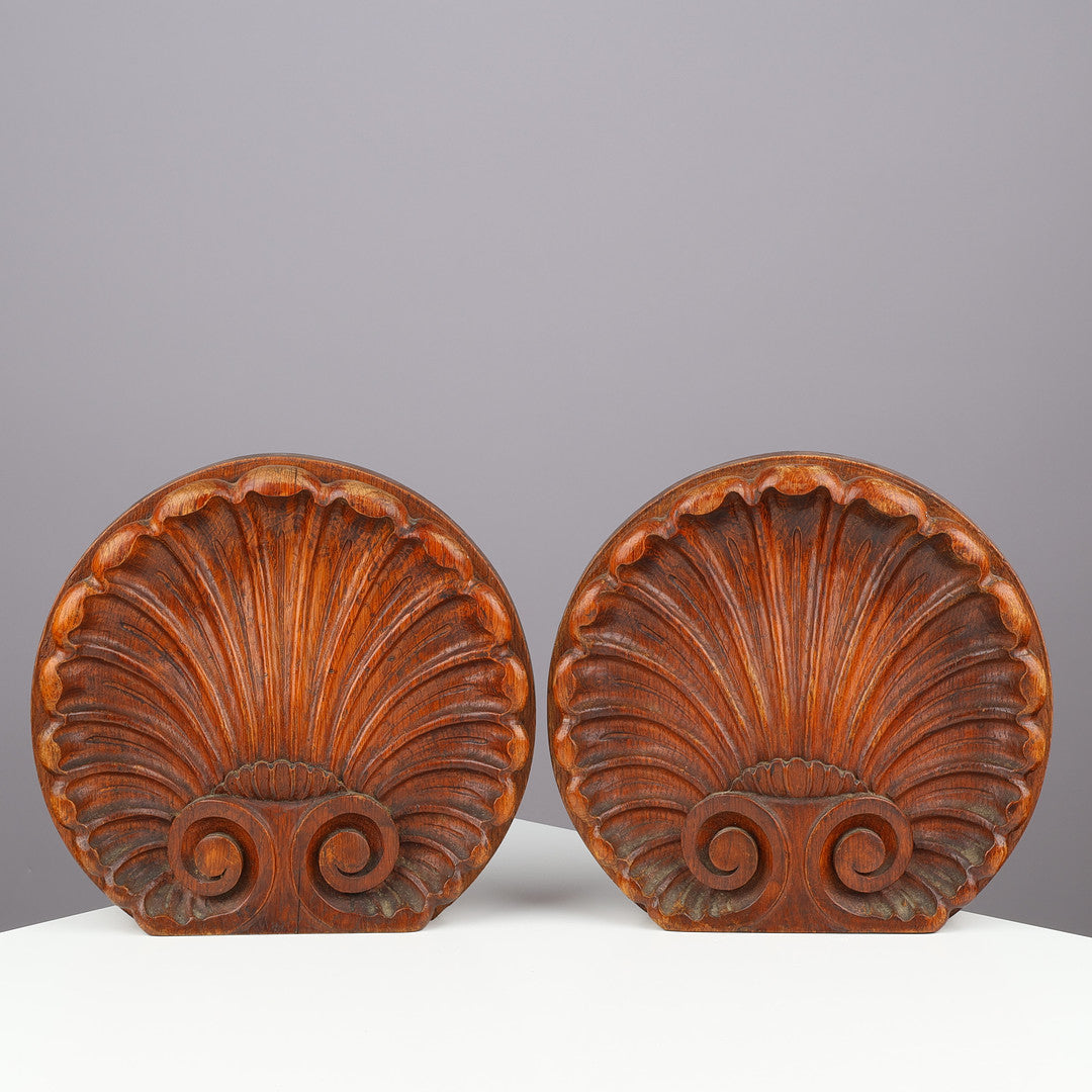 Pair of Danish carved oak scallop shell ornaments front view