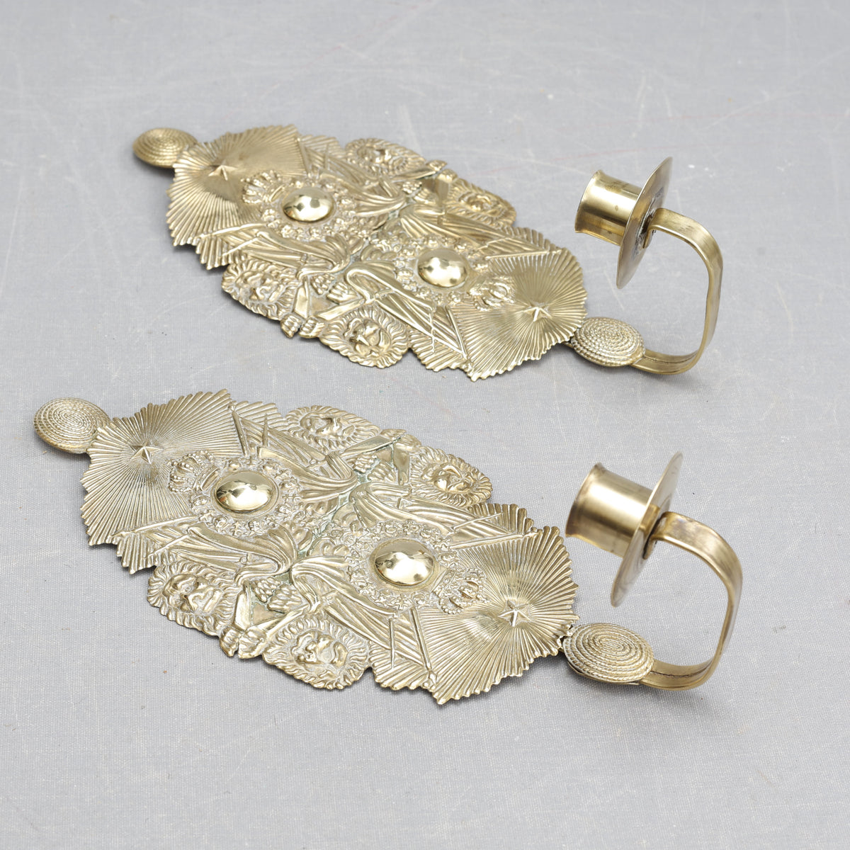 Pair of candle sconces made from military cap badges