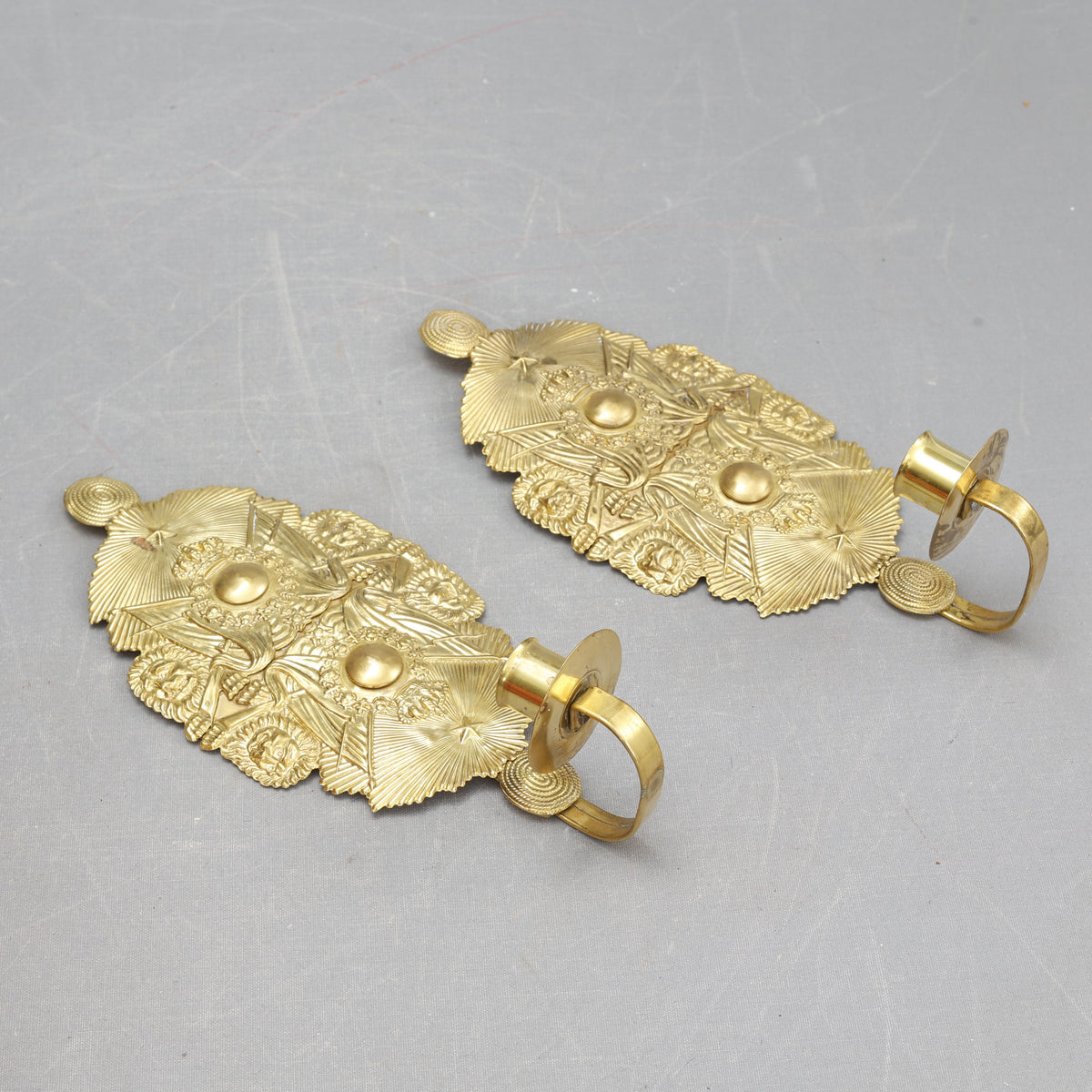 Pair of wall sconces made from military cap badges